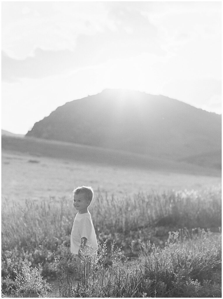 Toddler in field for a family photography session.