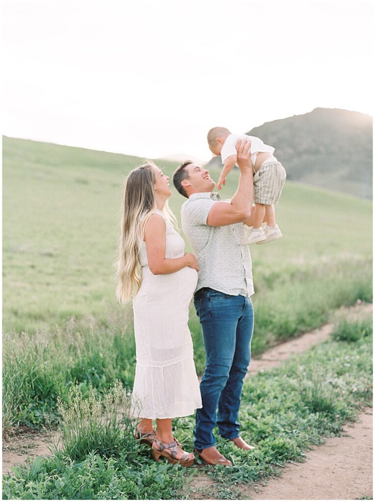 Family standing in field on path near denver photography by Chelsea Sliwa photography