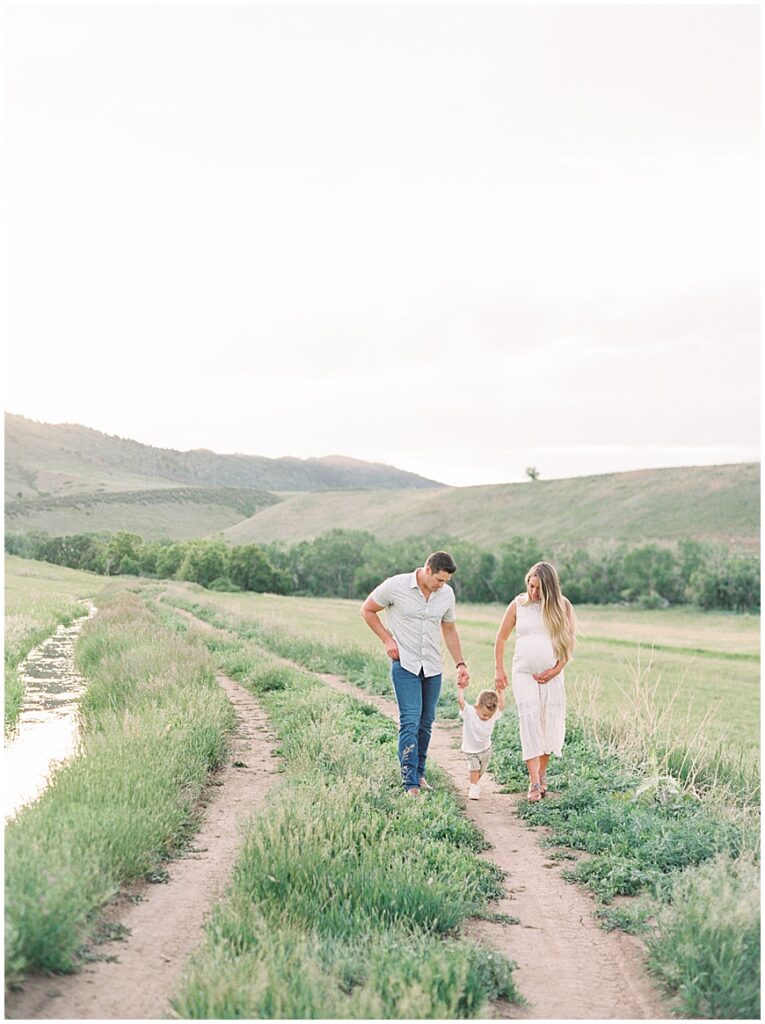 Family walking in field on path near denver photography by Chelsea Sliwa photography