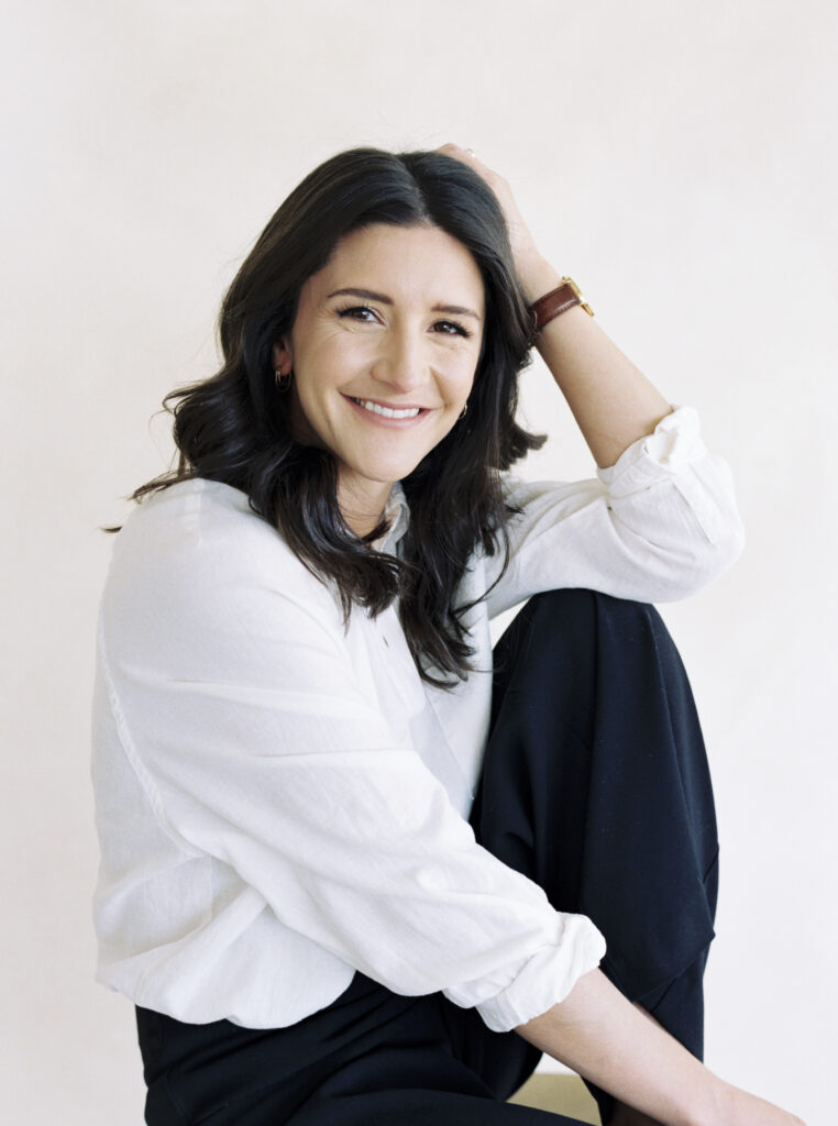 Greenville Photographer Chelsea Sliwa sits on a stool.