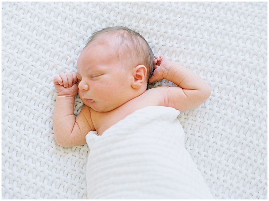 newborn baby on blanket during newborn session.