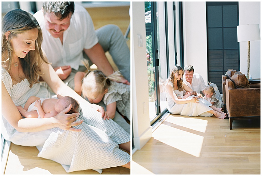 Baby, mother and father sitting in living room during newborn photography session.